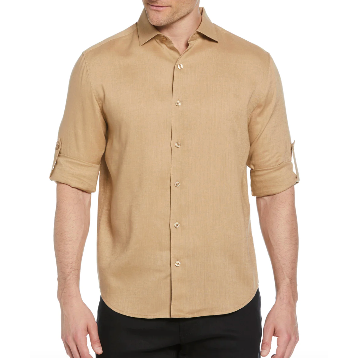 A beige long-sleeve shirt with roll-tab sleeves, button-up front, and a classic collar, worn with black pants.