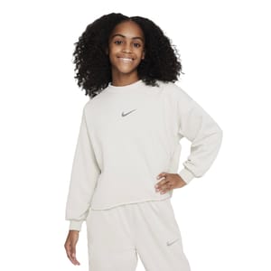 The Nike Girls' Fleece features a soft, cream-colored sweatshirt with the Nike logo on the chest, paired with matching pants also displaying the logo.