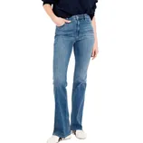 A person is wearing high-waisted, medium-wash flare jeans paired with a dark long-sleeve top and white sneakers.