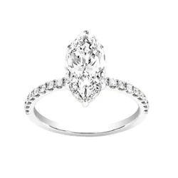 A marquise-cut diamond engagement ring features a central elongated diamond with a halo of smaller round diamonds set on a delicate band.