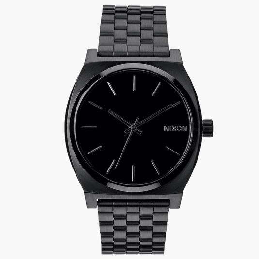 A black Nixon wristwatch with a minimalist design, featuring a black stainless steel band and a simple black analog dial with silver hour markers and hands.