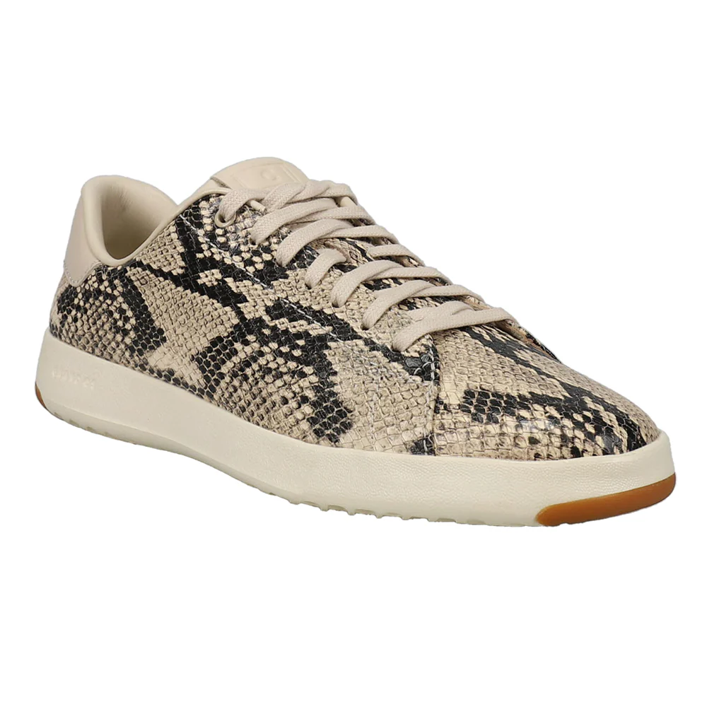 Cole Haan Snake Print Shoes feature a faux snakeskin pattern in beige and black, with a sleek, low-top design. They have beige laces and a white sole, adding a stylish texture to the casual look.