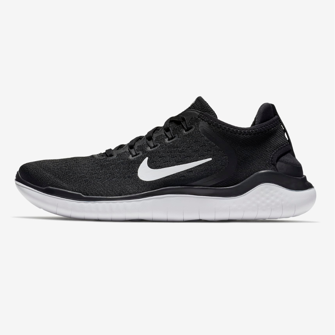 Black Nike Free Run 2018 shoes with a white swoosh logo and sole, featuring a flexible, low-profile design for natural movement.