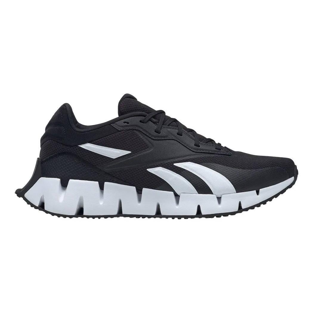A black and white running shoe with a jagged sole design.