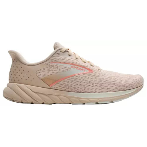 A beige running shoe with subtle orange accents, featuring a textured design and the Brooks logo on the side.