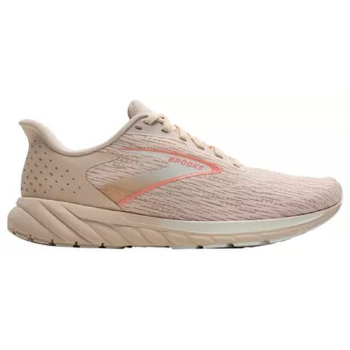 A beige running shoe with subtle orange accents, featuring a textured design and the Brooks logo on the side.