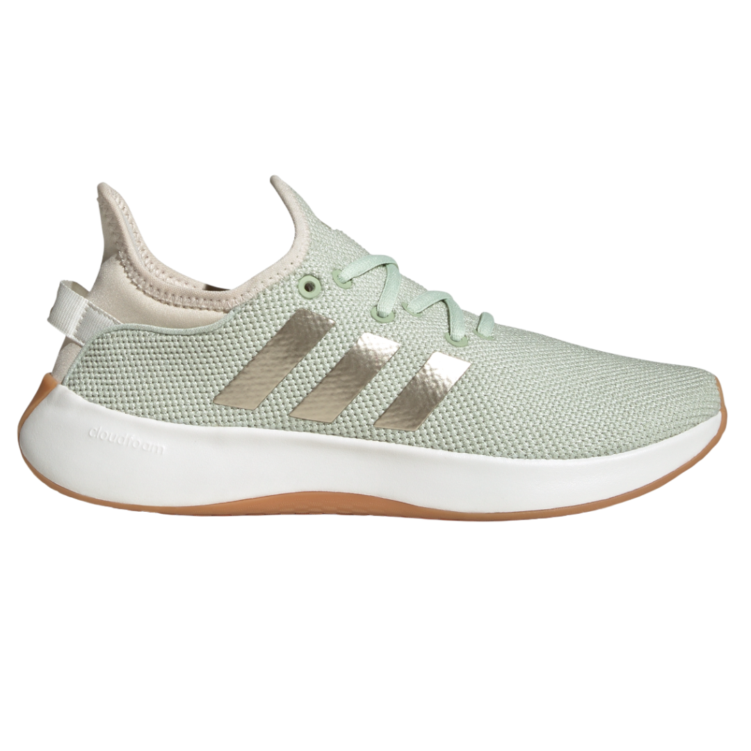 Sage green Adidas sneaker with metallic stripes, featuring \“Cloudfoam\“ cushioning and a light brown sole.