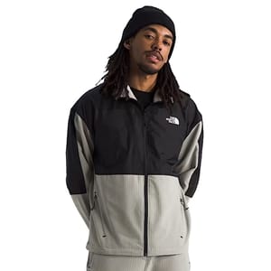 A man wearing a black and gray The North Face jacket and a black beanie.