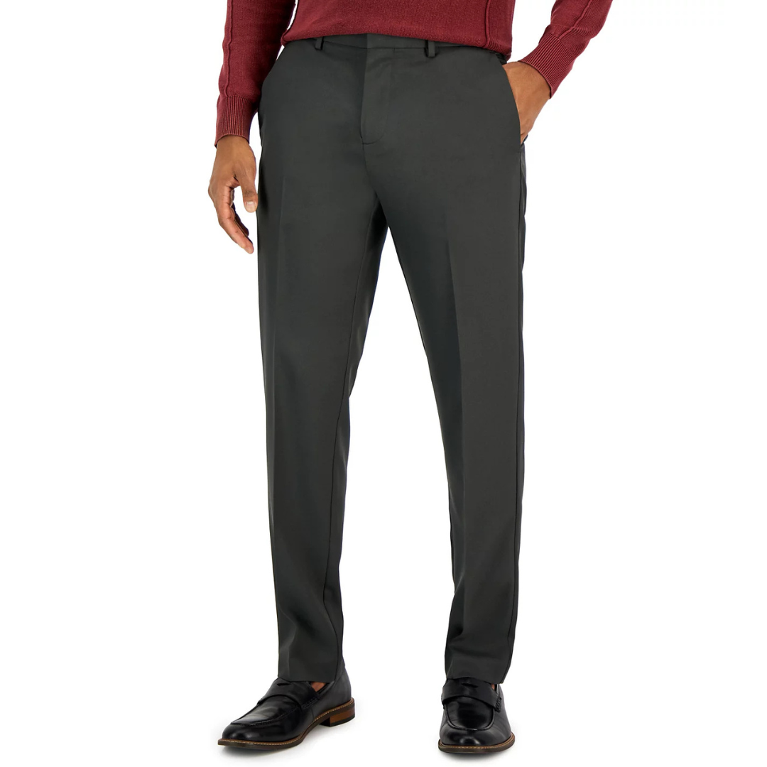 Perry Ellis Twill Pants are straight-fit, dark-colored trousers made from a smooth twill fabric. They feature front pockets and are paired with black leather shoes and a red sweater.
