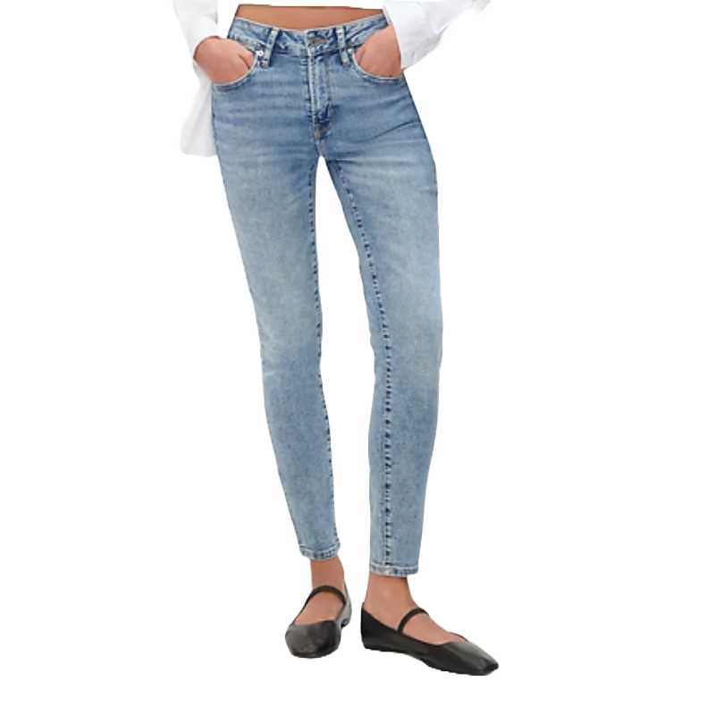 Light blue mid-rise jeans with a slim fit through the hip and thigh, tapering to a narrow ankle, paired with black flats and partially viewable white top.