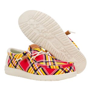 Colorful plaid casual shoes with white soles, featuring a mix of red, yellow, blue, and black patterns. They have white laces and a light brown tag detail.