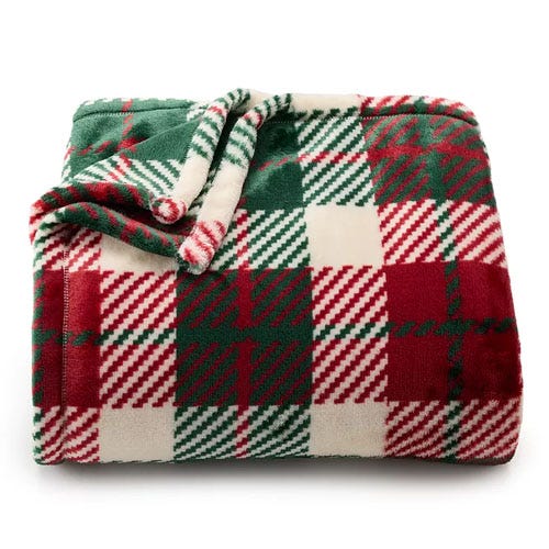 A folded red and green plaid fleece blanket.