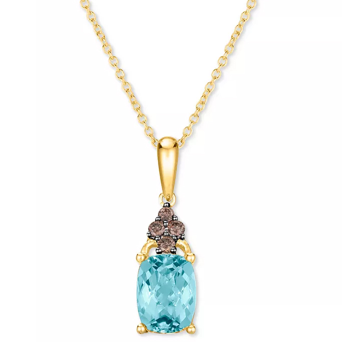 Gold necklace featuring a cushion-cut blue gemstone pendant adorned with small, dark stones in a floral design.