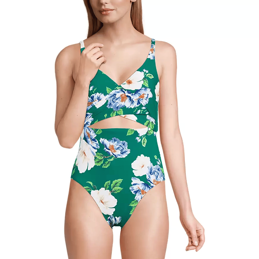 A green floral one-piece swimsuit with a cut-out design, featuring white and blue flowers and adjustable shoulder straps.