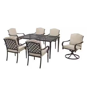 Outdoor dining set with a rectangular metal table and six cushioned chairs, including one swivel chair.