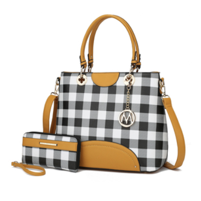 A stylish handbag and matching wallet feature a black and white checkered pattern with mustard accents and gold hardware, including a detachable shoulder strap and decorative charm.