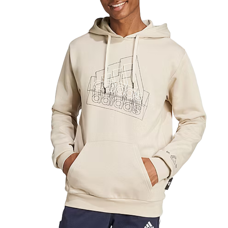A person is wearing a beige Adidas hoodie featuring a geometric design on the front, paired with dark pants displaying a small Adidas logo.
