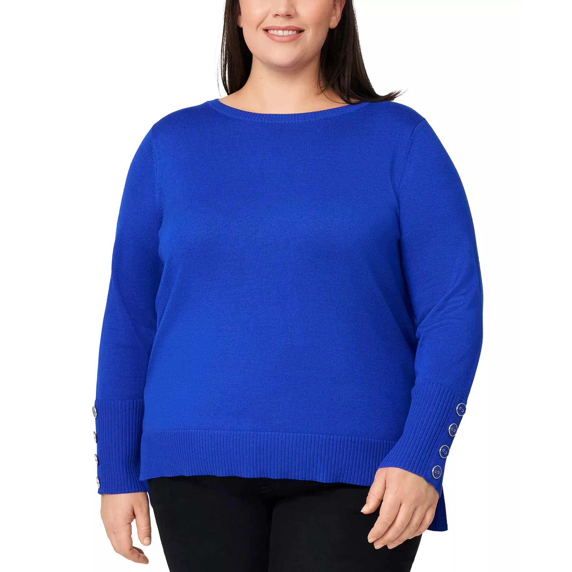 A plus-size woman is wearing a bright blue long-sleeve sweater with ribbed cuffs and button details on the sleeves, paired with black pants.