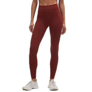 High-waisted, full-length maroon leggings paired with white athletic shoes.