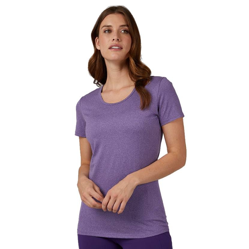A woman is wearing a plain short-sleeve purple T-shirt, paired with purple pants, standing against a white background.