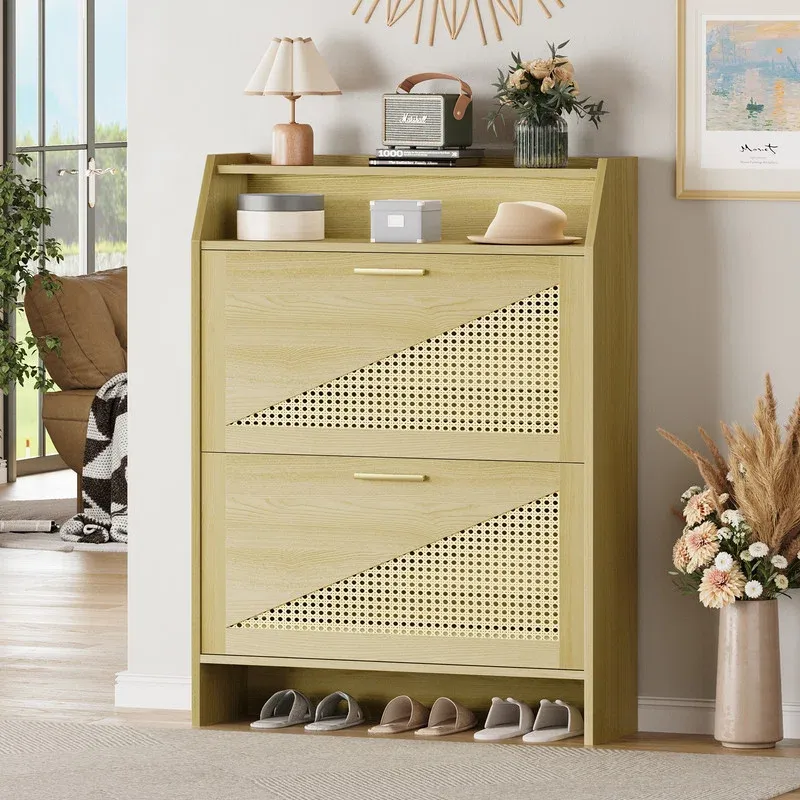 Wooden shoe rack with two pull-out drawers featuring triangular rattan panels, a top shelf with decorative items, and a section for storing shoes at the bottom.
