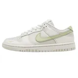 A white Nike low-top sneaker features an olive-green Swoosh and matching accents, with a clean, minimalist design.