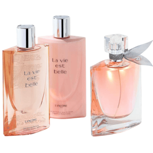Three \“La vie est belle\“ Lancome products are shown, including perfume and possibly body lotions, arranged on a white surface with jewelry in the background.