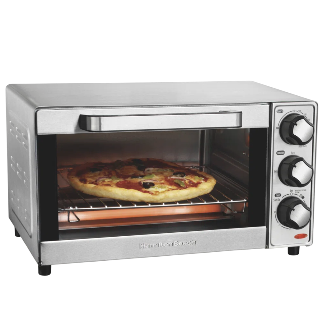 A countertop stainless steel toaster oven with three control knobs is baking a pizza on a wire rack.