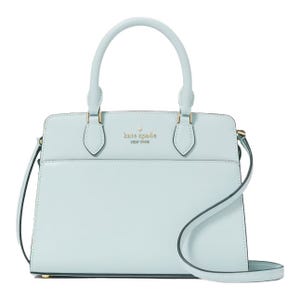 A pale blue Kate Spade handbag with gold accents and a detachable shoulder strap.