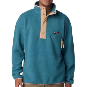 A person wearing a teal fleece pullover with a snap-button placket and contrasting trim, featuring a chest pocket with a zipper.