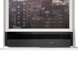 A sleek, black window-mounted air conditioner fitting into a raised window, with a view of urban buildings in the background.
