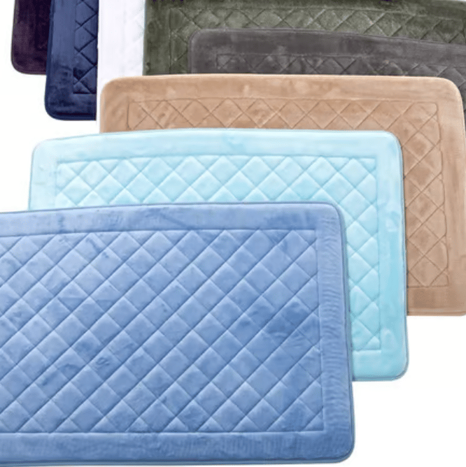 A collection of rectangular bath mats in various colors including blue, light blue, tan, green, and white, with quilted patterns.