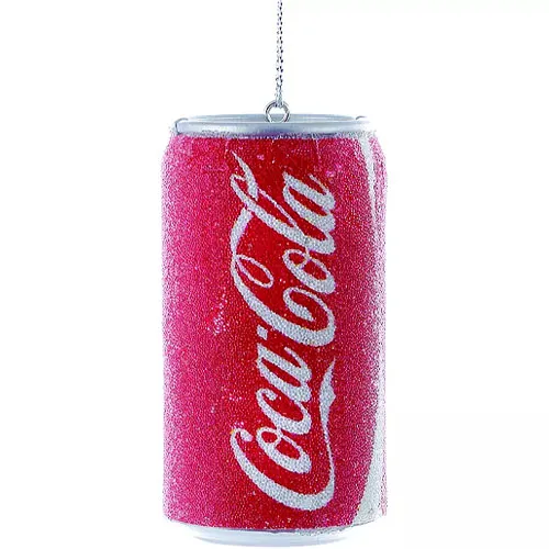 A decorative ornament resembling a red Coca-Cola can, featuring a reflective, glittery texture and a hanging chain at the top.