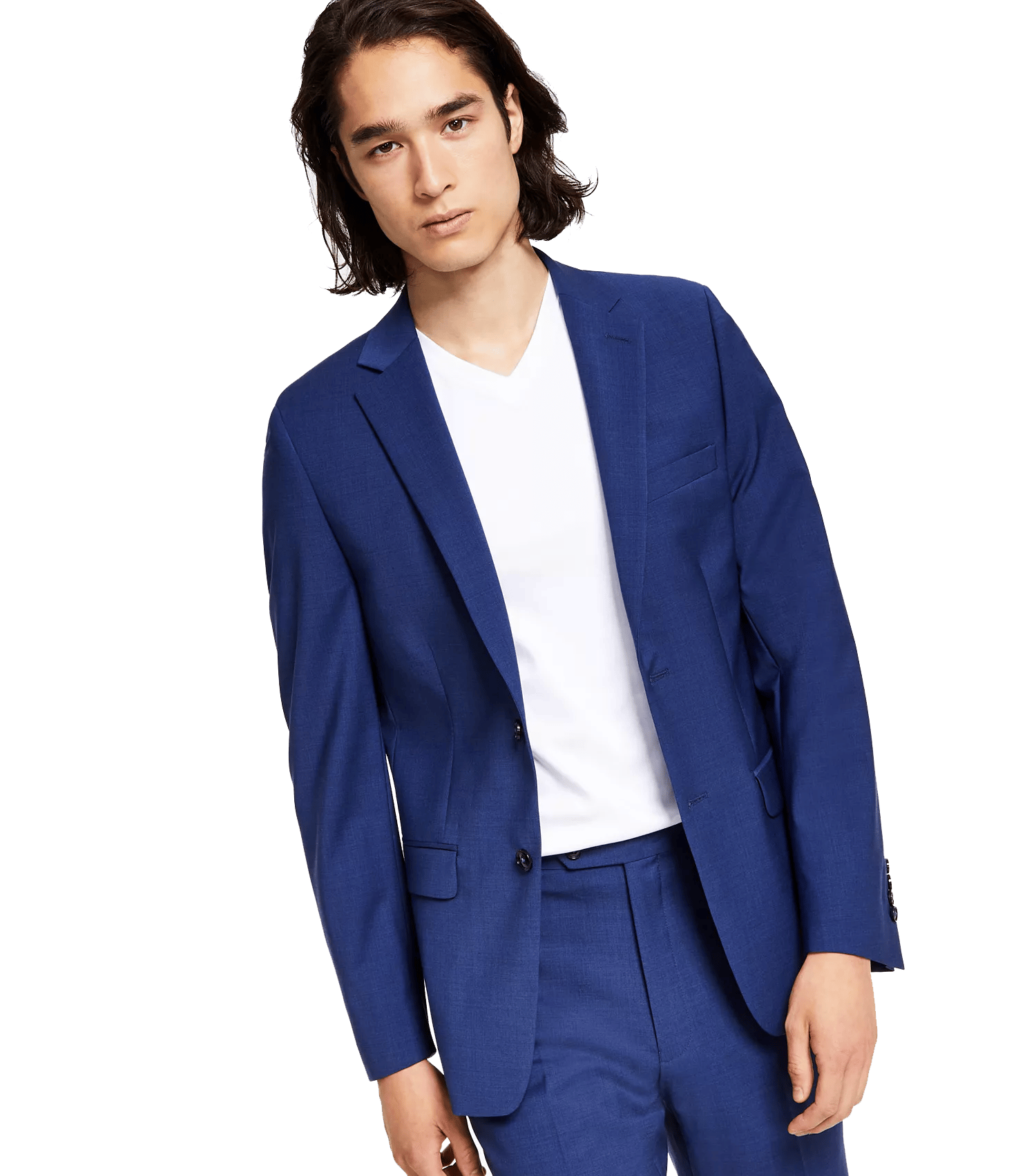 A person is wearing a blue suit with a white V-neck shirt underneath. The suit features a single-breasted jacket with button details.