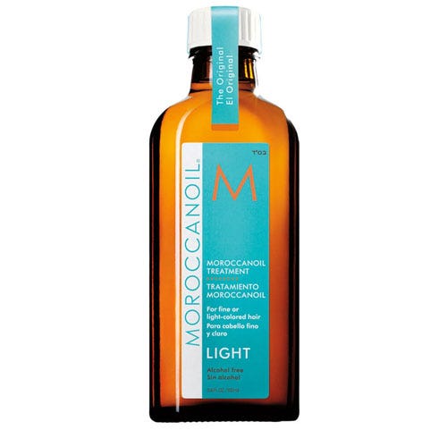 Moroccanoil Treatment Light, a hair treatment for fine or light-colored hair, alcohol-free formula in a clear amber bottle.