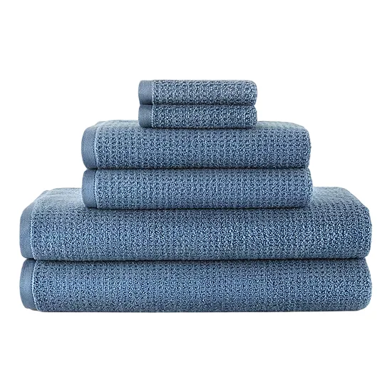 A stack of blue towels of varying sizes includes two large bath towels, two smaller hand towels, and two washcloths.