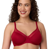 A woman wearing a red bra with mesh detailing at the top of the cups and thin adjustable straps, smiling and looking to the side.