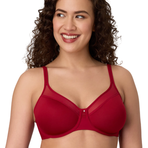 A woman wearing a red bra with mesh detailing at the top of the cups and thin adjustable straps, smiling and looking to the side.