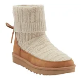 A tan suede boot featuring a ribbed, cream-colored knit upper with a fold-over cuff and tied detailing at the back. It has a flat, textured sole.