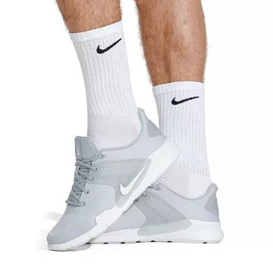 White crew-length socks displaying the Nike swoosh logo, designed with ribbed cuffs for a snug fit and cushioning for comfort.
