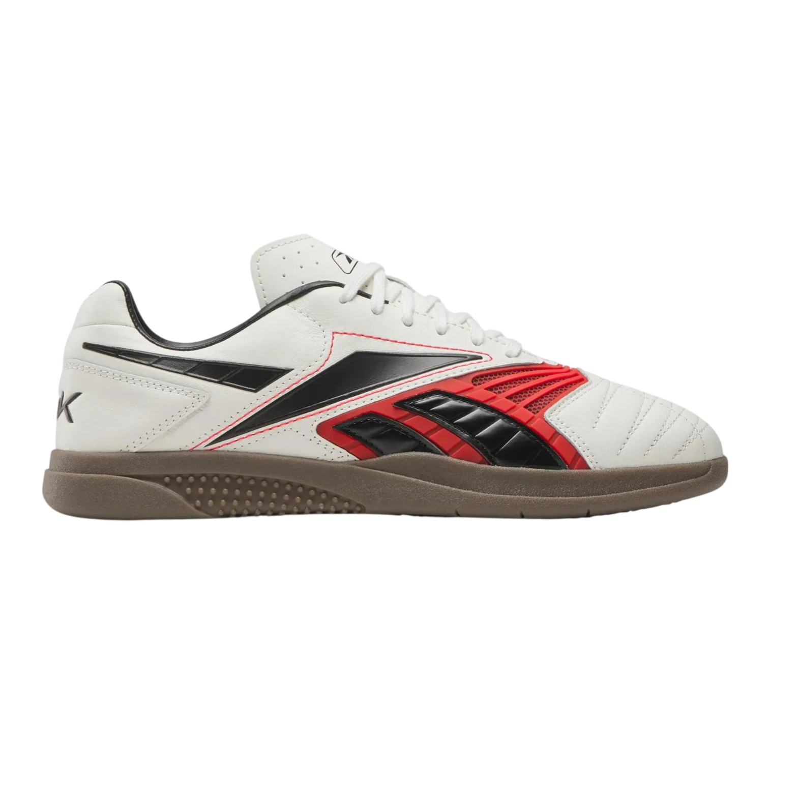 A white indoor soccer shoe with black and red accents, featuring a gum sole and lace-up design.
