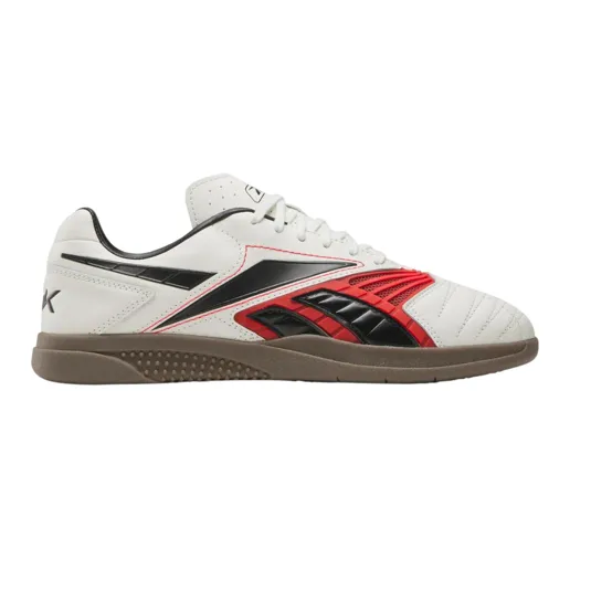 A white indoor soccer shoe with black and red accents, featuring a gum sole and lace-up design.