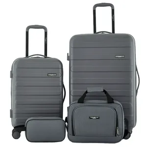 A set of grey luggage includes two rolling suitcases, a duffel bag, and a toiletry bag, all labeled \“Travelers Club.\“
