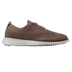 These Cole Haan Men's ZeroGrand Oxfords feature a brown knit upper with lace-up closure and a white, flexible segmented sole.
