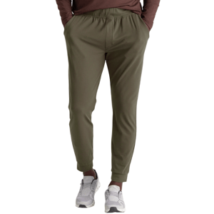 Olive green joggers with an elastic waistband and ankle cuffs, paired with gray sneakers.