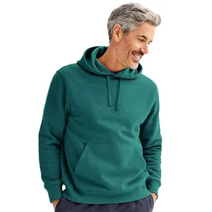 A man is wearing a green hoodie with a front pocket and drawstrings.