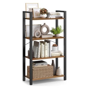 A four-tier bookshelf with a black metal frame and wooden shelves is filled with decorative items, including books, framed art, vases, plants, and a wicker basket.