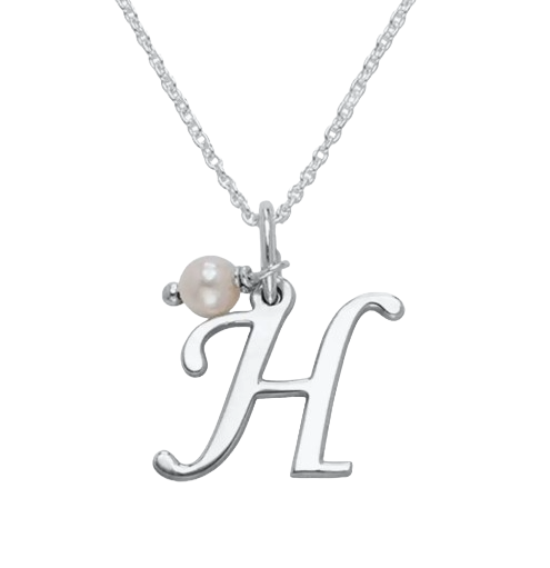 A silver necklace features a pendant in the shape of the letter \“H\“ accompanied by a small pearl charm.