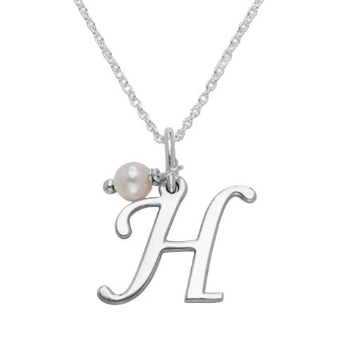 A silver necklace features a pendant in the shape of the letter \“H\“ accompanied by a small pearl charm.