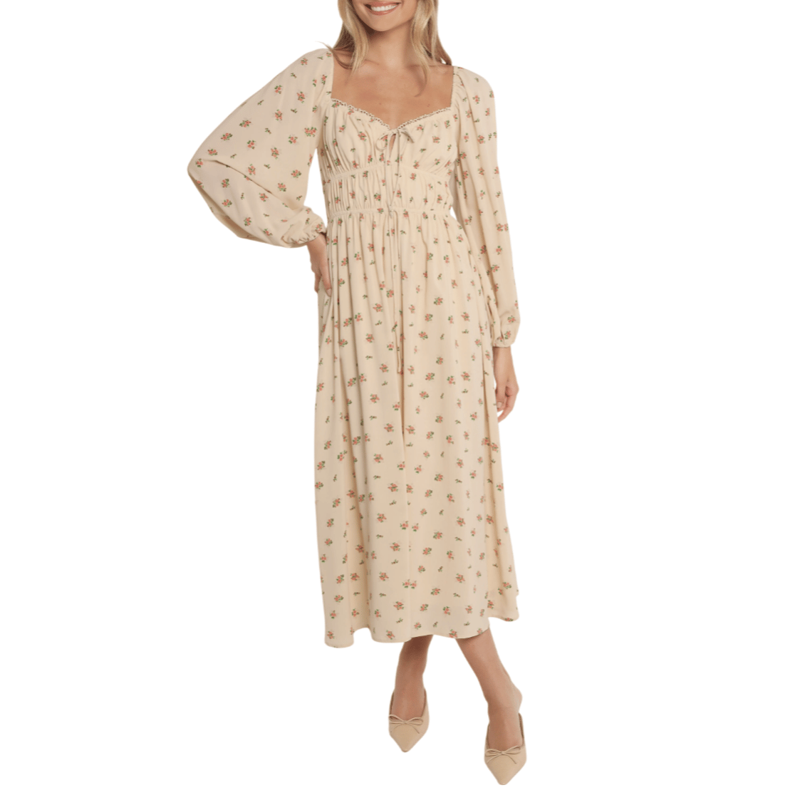 A cream-colored, long-sleeve, floral print dress with a square neckline and a gathered waistline, paired with beige pointed-toe flats featuring bows.